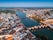 Photo of aerial cityscape of beautiful Tavira with roman bridge over Gilao river in the evening, Algarve, Portugal.