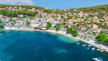 photo of a beautiful panoramic view of Kastel Luksic harbor and landmarks summer view, Split region of Dalmatia, Croatia.