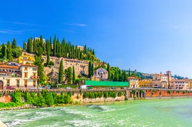 Photo of aerial view of Verona historical city centre, Ponte Pietra bridge across Adige river, Verona Cathedral, Duomo di Verona, red tiled roofs, Veneto Region, Italy.