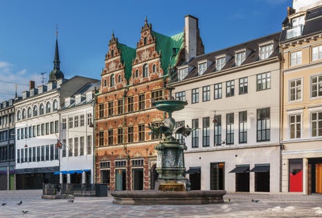 Photo of Stork Fountain on the Amagertorv (Amager Square) and the longest pedestrian street in the world Stroget in Copenhagen, Denmark.