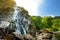 Majestic water cascade of Powerscourt Waterfall, the highest waterfall in Ireland. Famous tourist atractions in co. Wicklow, Ireland.