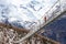 photo of girl in pigtails walks across the longest suspension bridge in the world - Charles Kuonen Suspension Bridge; walk across the fearsome bridge overlooking the mighty snowy alpine peaks, Switzerland.