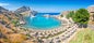 Photo of panoramic aerial view of St. Paul bay with acropolis of Lindos in background ,Rhodes, Greece.