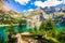 photo of amazing turquoise Oeschinnensee with waterfalls on a sunny summer day in Kandersteg, Switzerland.