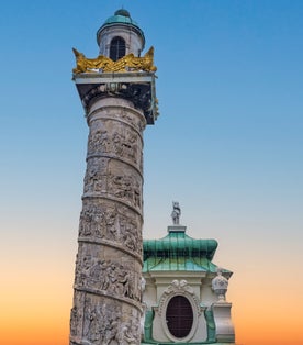 Photo of Pillar or the Historic Baroque church Karlskirche church in Karlsplatz in Vienna, Austria.
