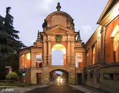 Photo of Italy Piazza Maggiore in Bologna old town tower of town hall with big clock and blue sky on background, antique buildings terracotta galleries.