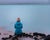 photo of Girl in blue jacket sits on the rocks and admires stunning blue colored lagoon near Gunnuhver Hot Springs. Hidden gems of Iceland .