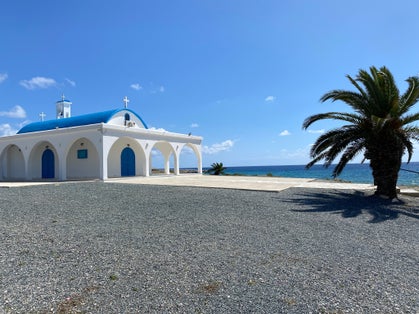 Scenic view of Ayia Thekla Chapel, tourist landmark attraction with scenic blue and white exterior facade at ocean sea coast of Cape Greco in beautiful landscape near Ayia Napa, Cyprus, Europe.