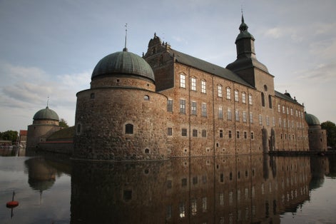 photo of Vadstena Castle with reflections in the moat in Vadstena, Sweden.