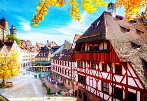 Photo of scenic summer view of the German traditional medieval half-timbered Old Town architecture and bridge over Pegnitz river in Nuremberg, Germany.