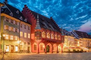 Photo of aerial view of the historic city center of Freiburg im Breisgau from famous old Freiburger Minster in beautiful evening light at sunset, Germany.