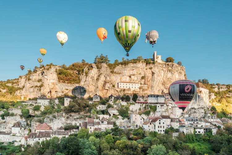 Hot air balloons pass over the medieval Chateau of Rocamadour in the Lot region of France during the Montgolfiades de Rocamadour balloon festival.jpg