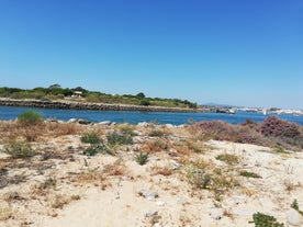 photo of an aerial view of wide sandy beach in touristic resorts of Quarteira and Vilamoura, Algarve, Portugal.