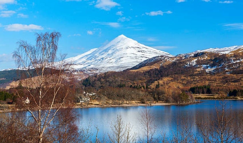 Schiehallion in Perthshire, Scotland, standing tall in late spring with its iconic cone-shaped peak rising above the east end of Loch Rannoch.jpg