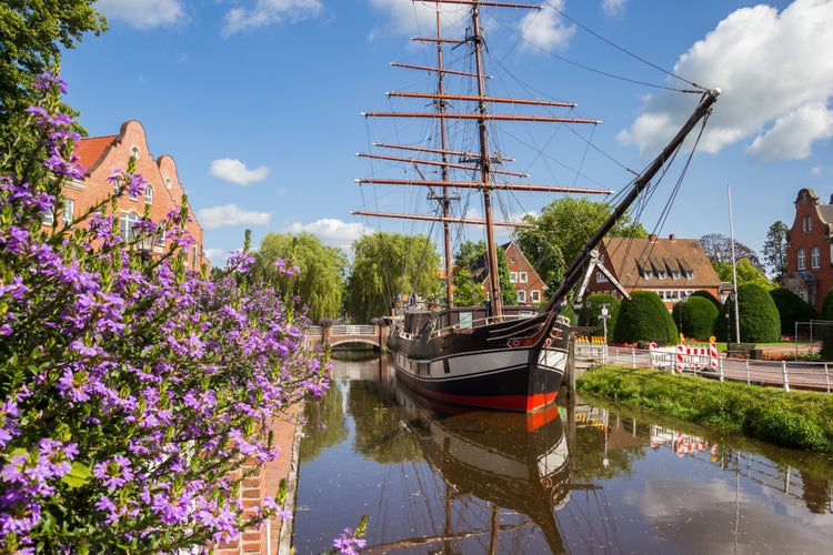 Photo of Purple flowers in front of the sailing ship in Papenburg, Germany