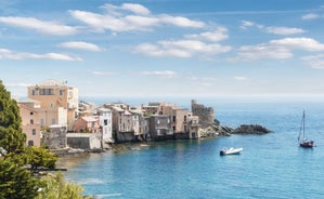 Photo of colorful houses on the shore of Bastia port, bright morning view of Corsica island, France.