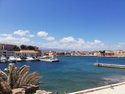 Photo of aerial view of Chania with the amazing lighthouse, mosque, venetian shipyards, Crete, Greece.