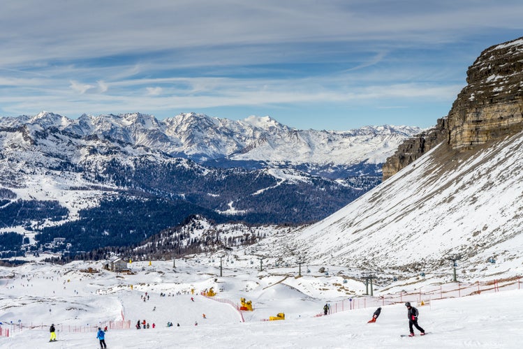 photo of a sunlit ski slope and a Gondola ski lift in the Ski Resort Madonna di Campiglio, South Tyrol, Trentino, Italy.