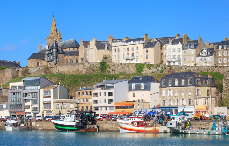 Gothic church on the hill and fishermen boats in port town Granville, Normandy, France