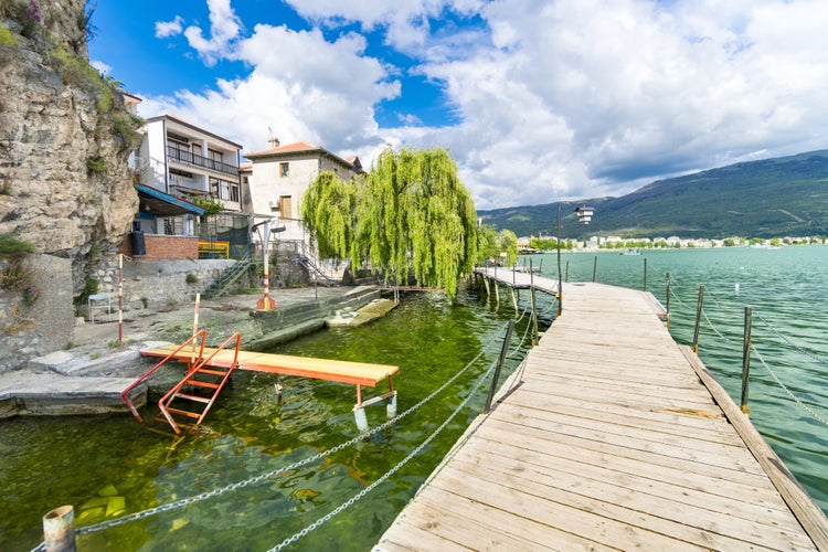 Photo of coastal scene with wooden walkway from Ohrid, North Macedonia.