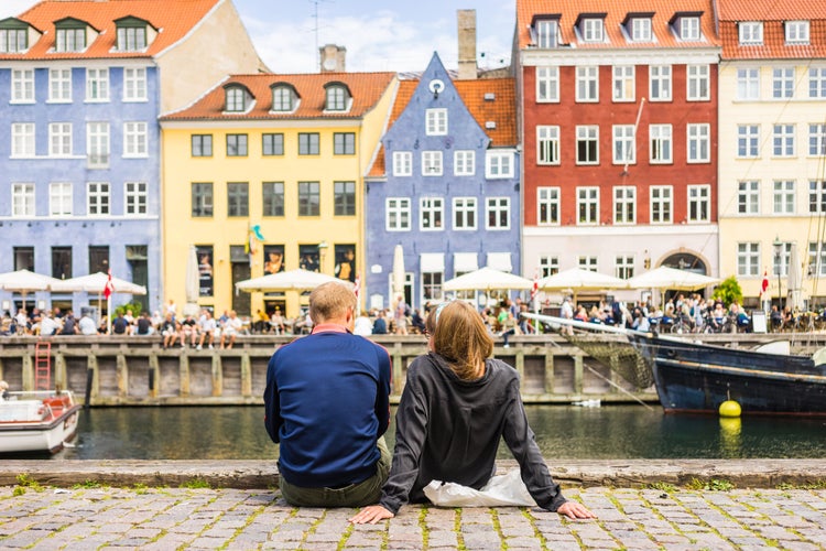 Photo of colorful building facades with boats and yachts in the Old Town of Copenhagen, Denmark