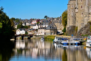 Photo of Vannes, beautiful city in Brittany, boats in the harbor, with typical houses and the cathedral in background, France.