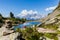 photo of Lake Spiegelsee Mittersee on Reiteralm and distant mountain range Dachstein in Styria, Austria.