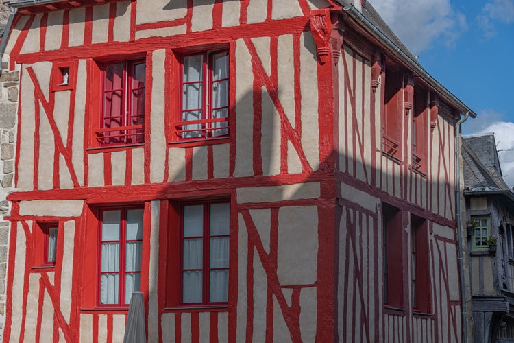 photo of view of historic half-timbered houses in Dinan city center, Brittany, France.