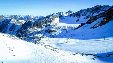 photo of an aerial view of Innsbruck, Austria during the winter morning, with snow and mountains at the background.