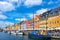 Photo of Scenic summer view of Nyhavn pier with colorful buildings and boats in Old Town of Copenhagen, Denmark.