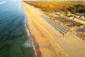 Photo of aerial view of pier fishing boats in the village Cabanas de Tavira, Portugal.