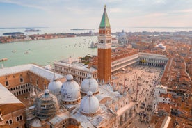 Famous buildings, gondolas and monuments by the Rialto Bridge of Venice on the Grand Canal, Italy.