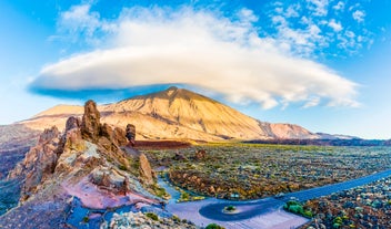 Photo of aerial view with Puerto de la Cruz, in background Teide volcano, Tenerife island, Spain.