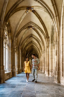 photo of couple men and woman walking by the church in Utrecht, Dom Church Utrecht, The Cathedral of Saint Martin Utrecht Dom Church Netherlands.