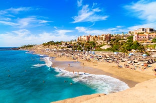 Photo of aerial view with Puerto de la Cruz, in background Teide volcano, Tenerife island, Spain.