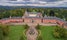 Photo of aerial view of Sychrov Castle with typical pink facade. Neo-Gothic style chateau with beautiful english style park, Czech Republic.