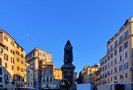 photo of colorful houses, old architecture and statue of Giordano Bruno in Campo de Fiori in Rome, Italy .