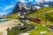 Photo of Cogwheel red passenger train in the small mountain station. Small train station on the shore of the Fallbodensee lake, Jungfraujoch, Bernese Oberland, Switzerland.