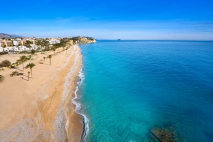 Photo of aerial panoramic view coastline and La Vila Joiosa Villajoyosa touristic resort townscape, sandy beach and Mediterranean seascape, Costa Blanca, Spain.