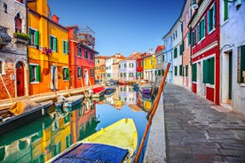 Famous buildings, gondolas and monuments by the Rialto Bridge of Venice on the Grand Canal, Italy.