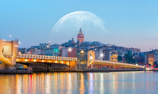 Galata Tower, Galata Bridge, Karakoy district and Golden Horn with full moon - istanbul, Turkey.