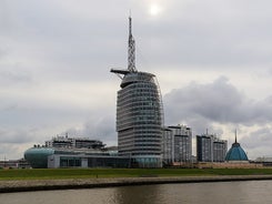 Photo of aerial view of the city of Bremerhaven with the harbor and traditional sailing-ships, Germany.