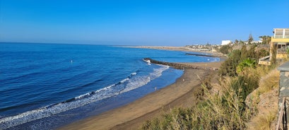 photo of landscape with Maspalomas town and golden sand dunes at sunrise, Gran Canaria, Canary Islands, Spain.