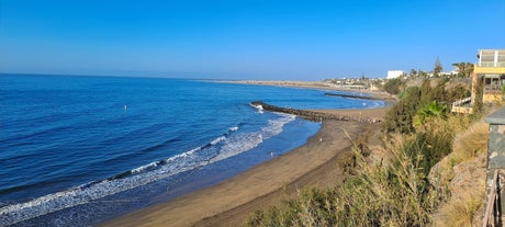 photo of landscape with Maspalomas town and golden sand dunes at sunrise, Gran Canaria, Canary Islands, Spain.