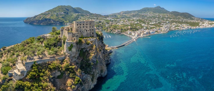 photo of Aerial view on Aragonese castle. The castle is the most impressive historical monument in Ischia, build in 474 BC. Aerial view of the island and town of Ischia.