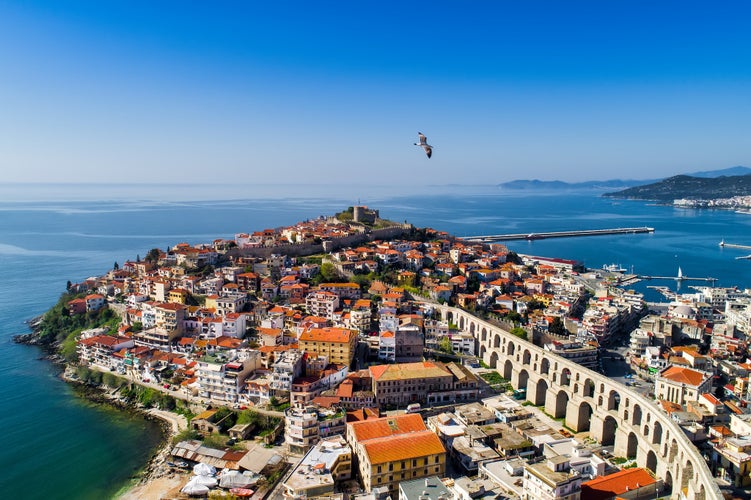 Photo of aerial view the city of Kavala in northern Greek, ancient aqueduct Kamares, homes and beaches.