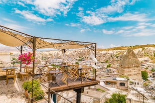 Hot air balloons flying over Uchisar Castle. Cappadocia. Nevsehir Province. Turkey.