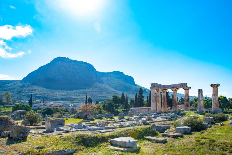 Photo of temple of Apollo with Acrocorinth in the background. Ancient Corinth, Greece.