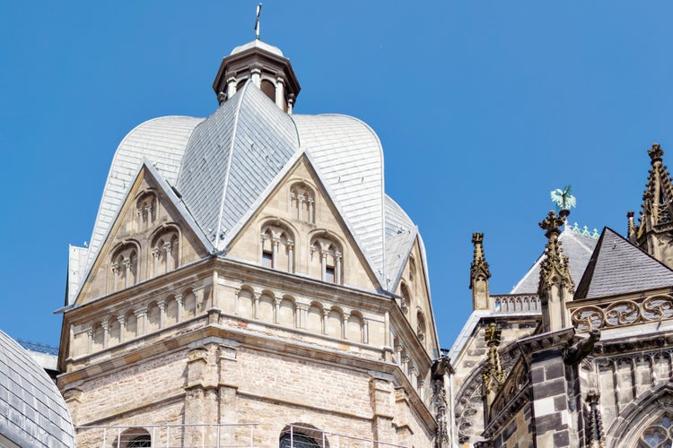 photo of view of Detail of medieval Aachen Cathedral exterior in Aachen Germany featuring cathedral walls with Gothic windows, towers, sculptures and ornaments.