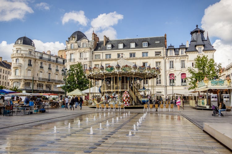 Orléans, France - Children playing in a flooded play area with water jets on the Place du Martroi in the city center of Orléans in the department of Loiret, Centre-Val de Loire, France